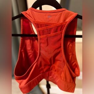 Burnt orange sports bra with phone pocket in the back.